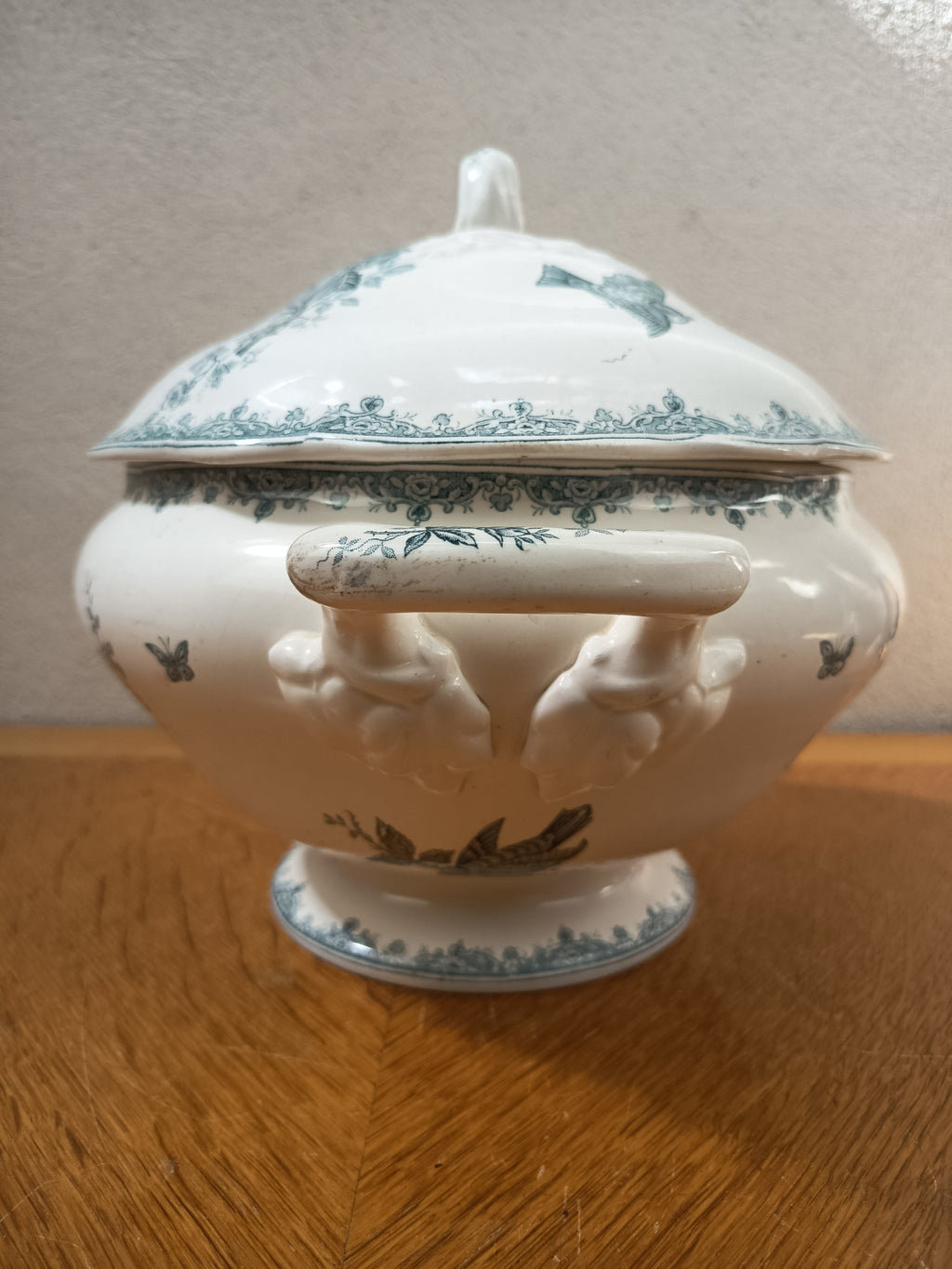 Soupière ancienne en terre de fer de Nimy Belgique, modèle Pinson, décor floral bleu-vert avec oiseaux et papillons, 24 x 30 cm.
